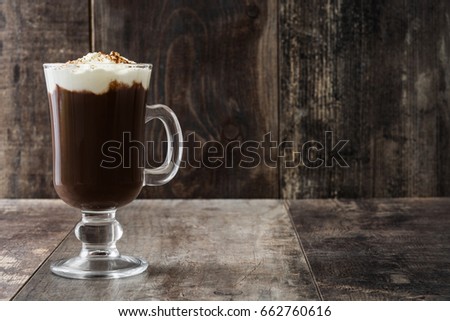 Irish coffee in glass on wooden background
