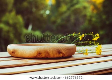 Empty wooden dish on the table in the open air