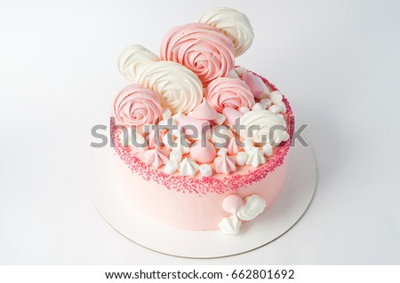 Birthday pink cake for girl, decorated with marshmallow, meringue cookies on a white background. Close-up. Cutout. Picture for a menu or a confectionery catalog.