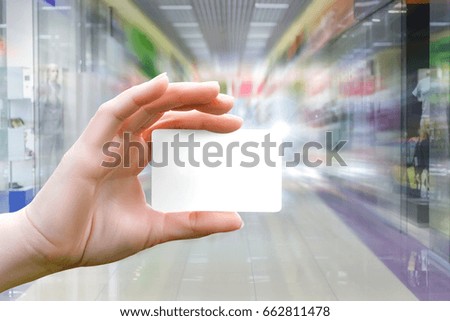 Shopping with credit card . Hand with the card .