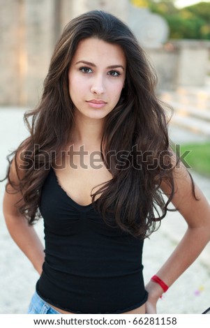Pretty multicultural young woman in an outdoor lifestyle fashion pose. Royalty-Free Stock Photo #66281158