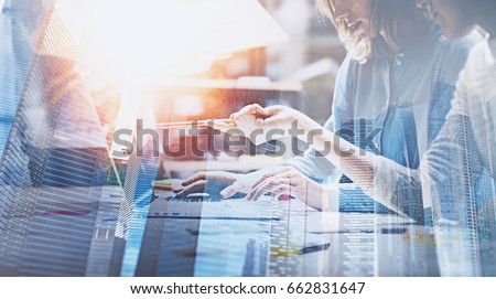 Business people working process concept.Young coworkers working together in modern office.Woman talking with colleague about new startup project.Double exposure,skyscraper building blurred background Royalty-Free Stock Photo #662831647