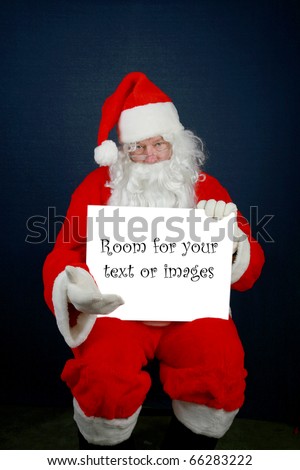 Santa Claus with enhanced blue eyes holds a blank white sign with room for your text or images