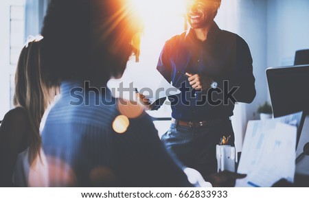 Teamwork people concept.Young team of coworkers making great business discussion in modern coworking office.Hispanic businessman talking with partners.Horizontal, blurred background, flares Royalty-Free Stock Photo #662833933