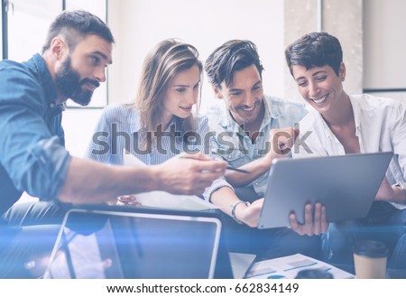 Teamwork process.Young entrepreneur work with new startup project in office.Woman holding touch pad in hands,bearded man pointing to screen.Horizontal, blurred, flare. Royalty-Free Stock Photo #662834149