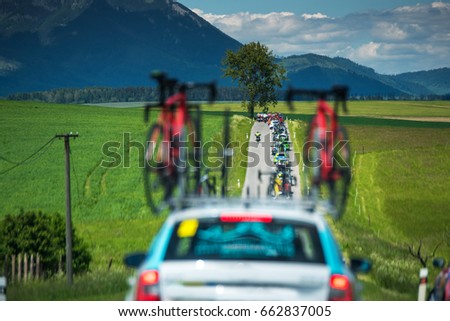 Bicycle on the roof of service car during professional cycling race