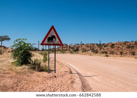 Elephant crossing with sign on the road in Namibia