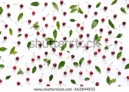 Cherries and green leaves isolated on white background. Pattern of cherry with green leaves. Abstract food background. Top view.	