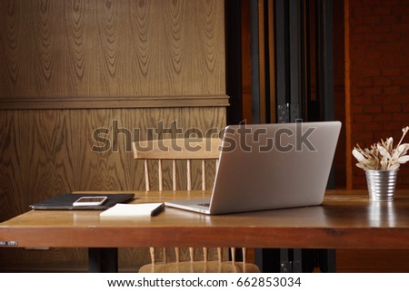 Supplies and gadgets on wooden table and chair at the cafe. Digital no mad lifestyle. Stock Photo