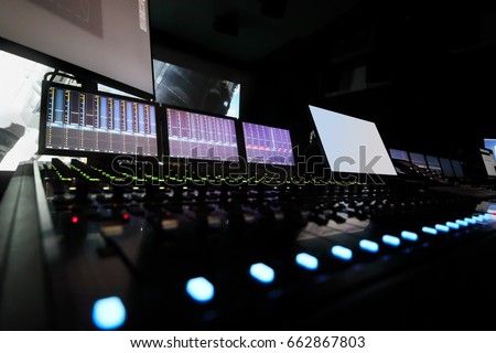 Dark recording studio with modern equipment on movie studio, cinema display out of focus