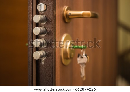 The keys in the lock of the door, on the outside, safety, locked doors, security, privacy Royalty-Free Stock Photo #662874226