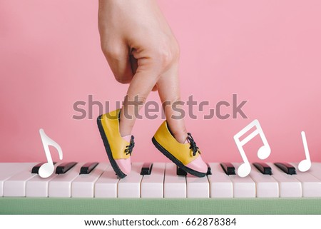 woman hand finger walking on piano between music note with shoe concept, Music lesson school education concept, Dance exercise for good healthy. 