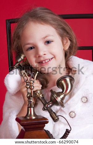 Cute little girl with an old phone