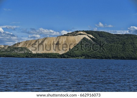 Chalky mountain near water extraction of chalk industry