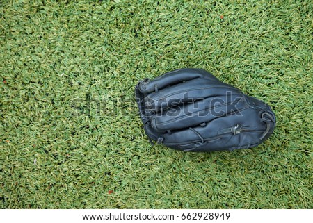black glove for softball on grass field