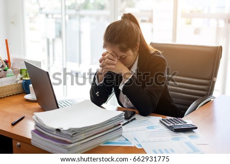 Business woman feeling stress from work in the office Royalty-Free Stock Photo #662931775