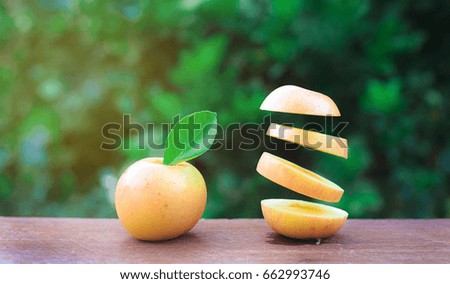 Apples on the wood and flying slices, Background of nature. Dark tone