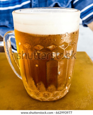 A mug of cold beer on the table
