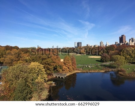 View of Turtle Pond and the Great Lawn in Central Park from Belvedere Castle on a clear summer day.  Blue skies a few clouds. View of Central Park New York.