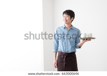 asian man working  at a cafe