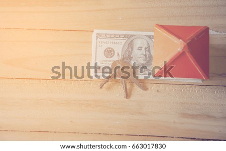 Houses made of paper, keys and money on a wooden background