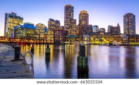 The skyline of Boston in Massachusetts, USA at night showcasing its mix of contemporary and historic architecture at Boston Harbor and Financial District.