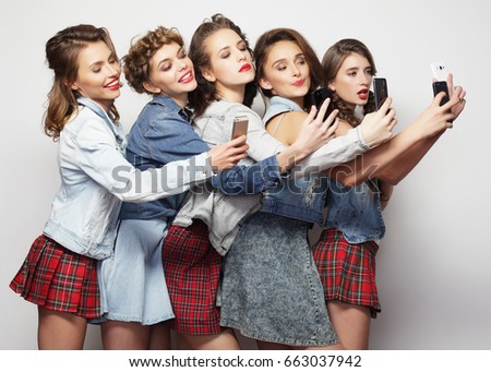 lifestyle, technology and internet concept:group of young women looking at their smartphones 