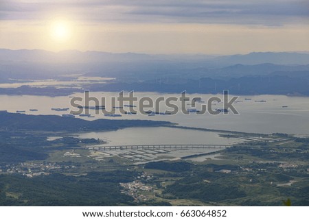 Early in the morning, China's largest freshwater lake is photographed from the famous Mount Lu in china. Slight haze weather. Mystery screen background.