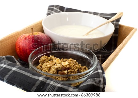 Healthy breakfast with yoghurt and muesli on tray