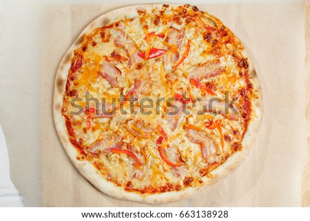 Pizza italian with bacon and paprika on a paper.
