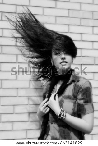 Girl with flying hair in a black and white vintage photo