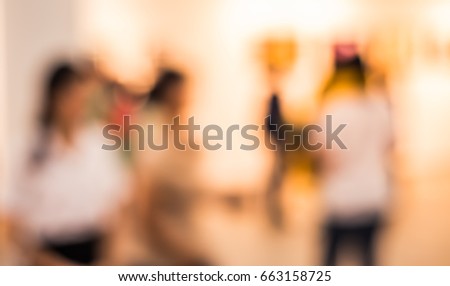 Abstract Blurred image of people at Art gallery or Exhibition hall for background usage . (vintage tone)