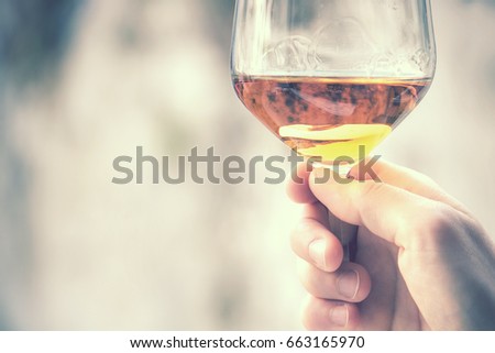 glass of wine vintage effect, defocused background with copy space (retro style picture)

