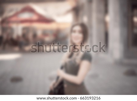 blurred photo of a girl standing on the street