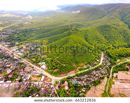 Aerial view of Mae Sariang city with communication towers ontop of the mountain, Hillside village at Mae Hong Son province unseen Thailand.