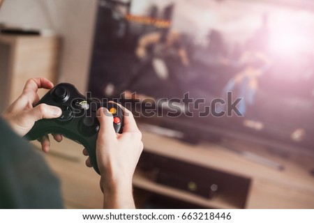 The guy is playing on the console Royalty-Free Stock Photo #663218446