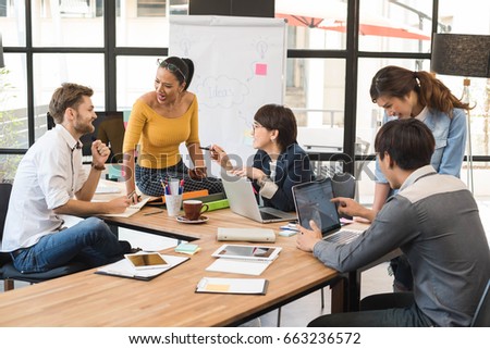 Group of five creative worker brainstorm together in office, new style of workspace, happy scene of people in office