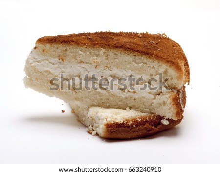 a piece of pound cake with cottage cheese on a white background/sponge cake/isolated objects