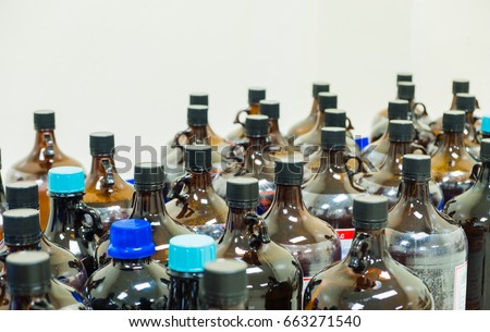 The many of amber glass bottle contains chemical hazardous waste from the laboratory, selective focus Royalty-Free Stock Photo #663271540