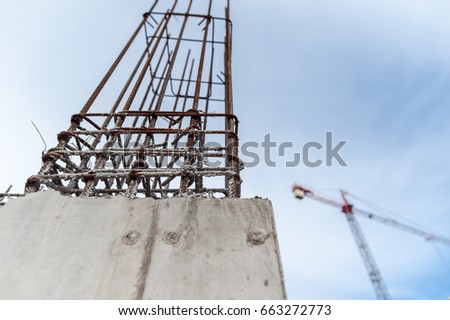 Concrete wall for a building under construction with crane on background