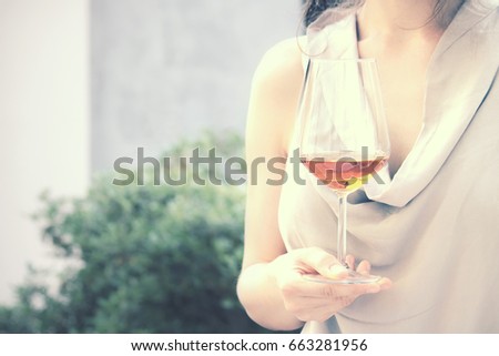 fashion girl holding wine glass, tasting drink outdoor (vintage picture effect)