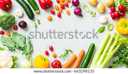Kitchen - fresh colorful organic vegetables captured from above (top view, flat lay). Grey stone worktop as background. Layout with free text (copy) space.