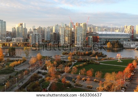 Park in front of Vancouver skyline in fall showing seasonal colours