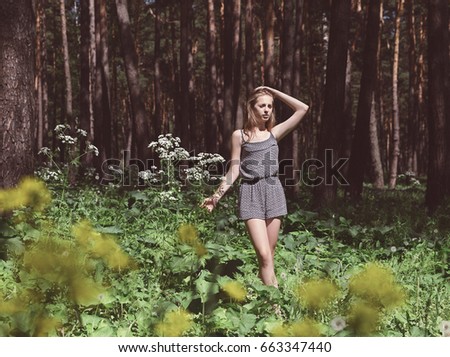 Girl in a pine park in the summer.