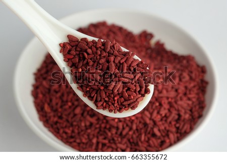 Dried red yeast rice on bowl and spoon Royalty-Free Stock Photo #663355672