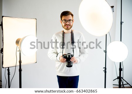 Young male photographer in studio