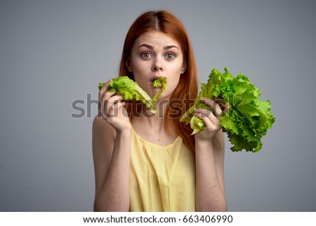 Woman with lettuce, woman on diet, eating right, woman on gray background                               