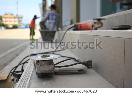 Machine cutting a tile at construction site