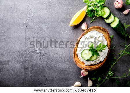 Tzatziki Traditional Greek sauce with ingredients cucumber, garlic, parsley, lemon. Food Background.Snack, Meze in the dishes of the Olive Tree.Copy space for Text.selective focus.