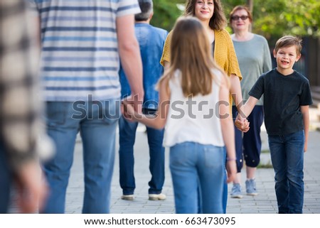 
Moms and dads are walking with children in the park in good weather